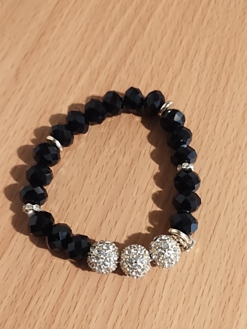 Like New Size 9 Wrist Black Faceted Bead Bracelet with Gold Crystal Accent.